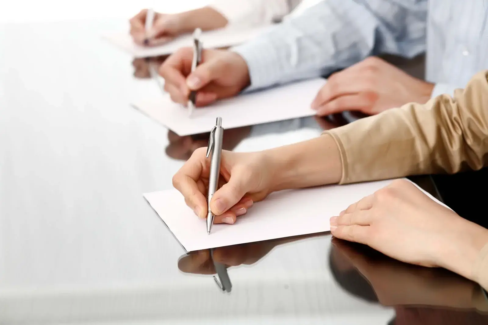 Line of writing hands.